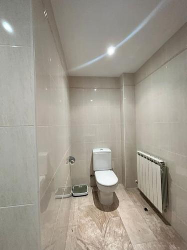a bathroom with a white toilet in a room at Ca L’Anna in Tremp
