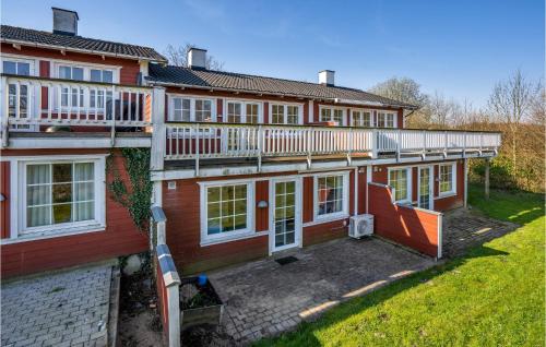 a large red house with a balcony and a yard at 3 Bedroom Beautiful Home In Aabenraa in Aabenraa