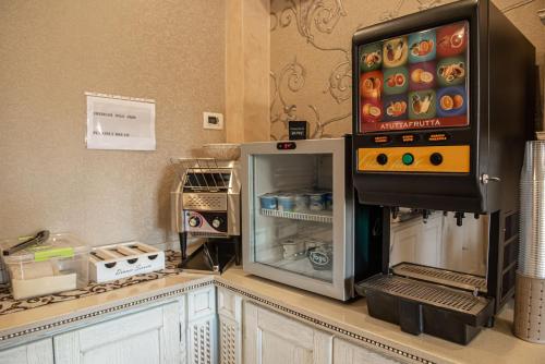 a kitchen with a counter with an open refrigerator at Hotel Bellavista in Marina di Varcaturo