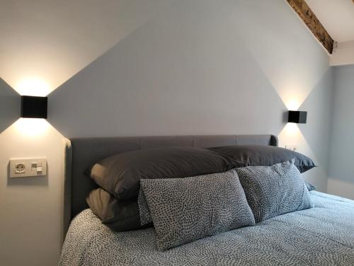 a bedroom with a bed with two lamps on it at Gran Via 16 Bilbao centro LBI00574 in Bilbao