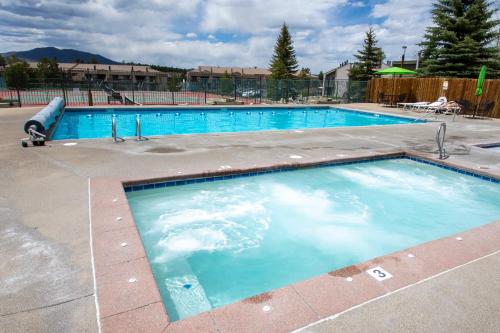 a large swimming pool with blue water at Meadowridge Court 19 Unit 1 in Fraser