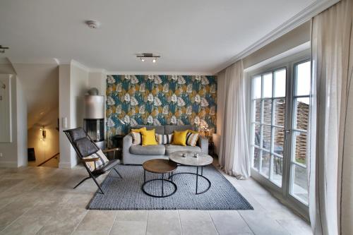 a living room with a couch and a table at ApartHotel Seepferdchen in Hörnum