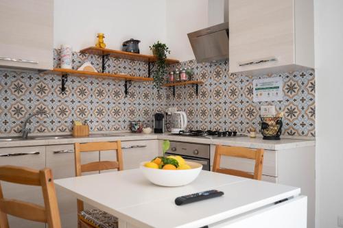 a kitchen with a bowl of fruit on a counter at Light Garden in Taormina