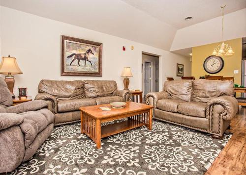 a living room with couches and a coffee table at Smokin Views Whispering Pines 651 in Pigeon Forge