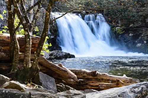a waterfall in front of a river at Smokin Views Whispering Pines 651 in Pigeon Forge