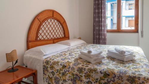 a bedroom with a bed with two towels on it at Sea view balcony in Cala Gonone