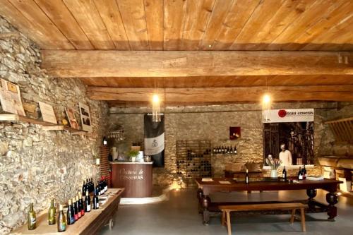 a wine tasting room with a stone wall and a table at Grande villa de vacances avec piscine - 6 chambres in Cesseras