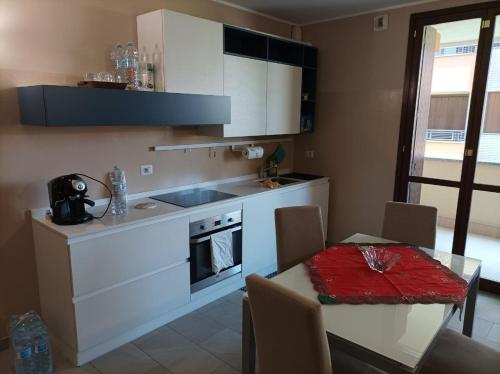 a kitchen with a table and a stove top oven at Camera doppia privata vicino Milano con bagno in comune in Concorezzo