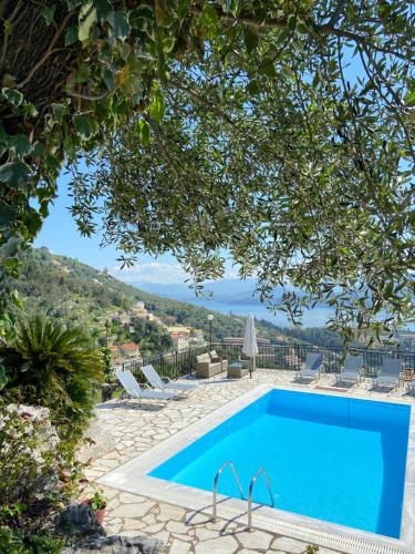 a swimming pool with a view of a resort at Villa Chrysoula in Kalami