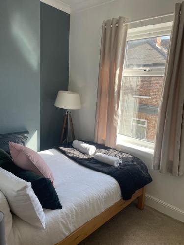 a bedroom with a bed with a window and a lamp at Country File in York