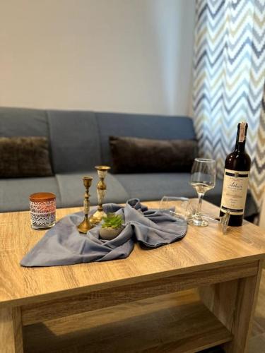 a table with a napkin and two bottles of wine at Lydia's cozy house in Paradeísion