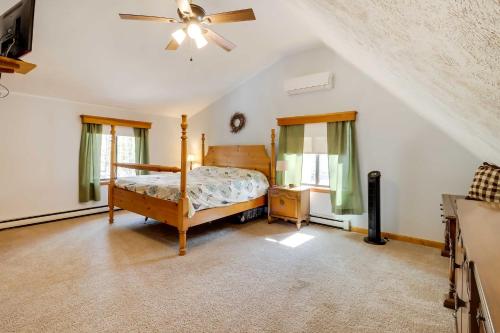 a bedroom with a bed and a ceiling fan at Spacious Pocono Lake House Near Skiing and Swimming! in Pocono Lake