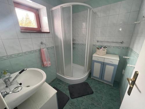 a bathroom with a tub and a sink and a shower at Chata Fialka in Veľký Slavkov