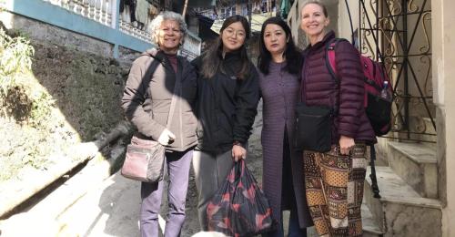 a group of women posing for a picture on some stairs at DukeRaj Homestay in Darjeeling