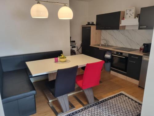 a kitchen with a table and two chairs and a kitchen with black cabinets at TWO Self-Check-In, 3km freeway, Free-Parking Playstation in Wolfpassing an der Hochleithen