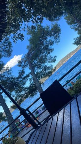 a bench sitting on a deck looking up at the water at Peponi Del Mar II in Biograd na Moru