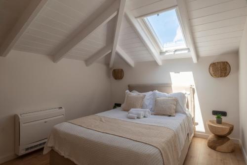 a bedroom with a bed with a window at Archico in Gialova