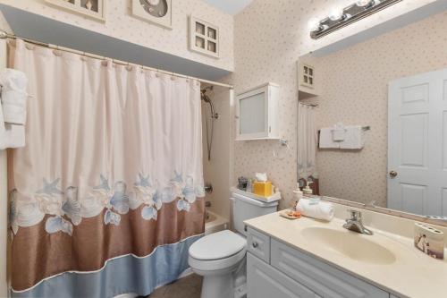 a bathroom with a toilet and a sink and a shower curtain at NEW! Gated Community, Pools, Gym, Beach @ Ocean Keyes #1721 in Myrtle Beach