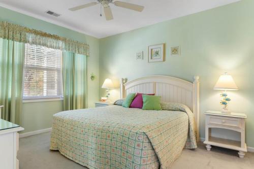 a bedroom with a bed with green walls and a window at NEW! Gated Community, Pools, Gym, Beach @ Ocean Keyes #1721 in Myrtle Beach