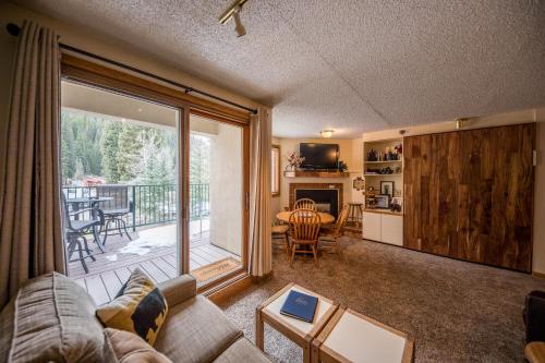 a living room with a couch and a large window at Iron Horse Building C Unit 1023 in Winter Park