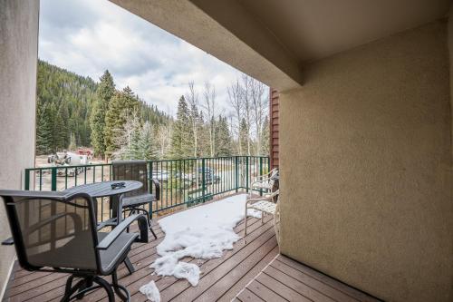 a balcony with a table and chairs on a deck at Iron Horse Building C Unit 1023 in Winter Park