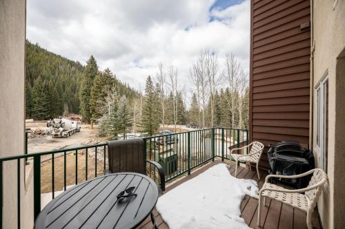 a balcony with a table and chairs and a view of a field at Iron Horse Building C Unit 1023 in Winter Park
