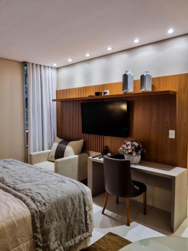 a hotel room with a bed and a desk at Ananda Pousada in Pirenópolis