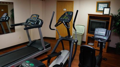 a gym with two exercise bikes and a television at Hotel Grand Victorian in Branson