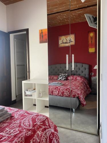 a bedroom with a bed and a red wall at Bed&Wine in Brisighella