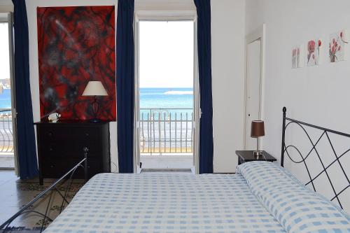 a bedroom with a bed and a view of the ocean at Maridea - Il Delfino in Ponza