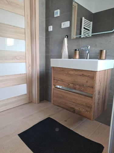 a bathroom with a sink and a mirror at Chata Štíty in Štíty