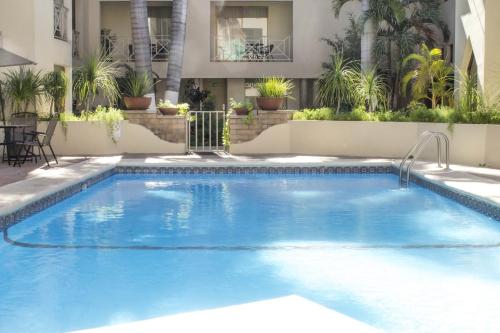 a large swimming pool with blue water at Wyndham Garden Obregon in Ciudad Obregón