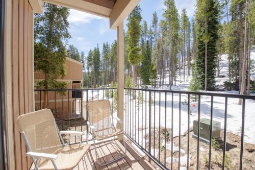 a screened porch with two chairs and a grill at Beaver Village Unit #0221 in Winter Park