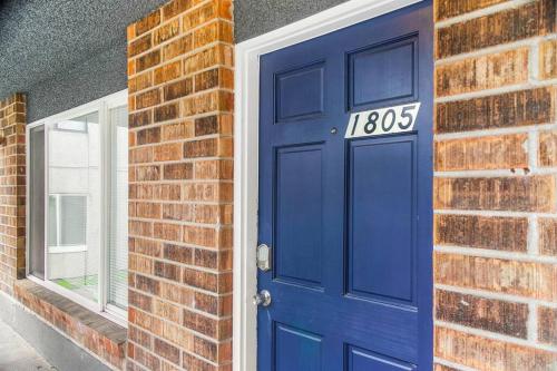 a blue door on a brick wall with a house at Seattle Cloud 2BR Prime Location in Seattle