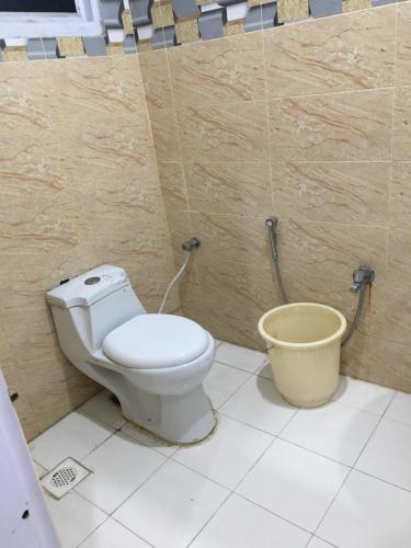 a bathroom with a toilet and a bucket at Three star Hotel & Rest in Malam Jabba