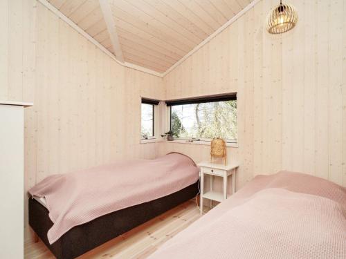 a bedroom with two beds and a window at Holiday home Hundested XI in Hundested