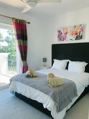 a bedroom with a large bed with towels on it at Detached Villa 4 bed Duquesa with Private infinity pool close to port and beach in Manilva