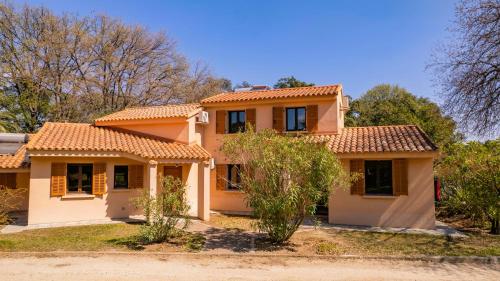 a house with an orange tiled roof at Residence Mare e Sole in Taglio-Isolaccio