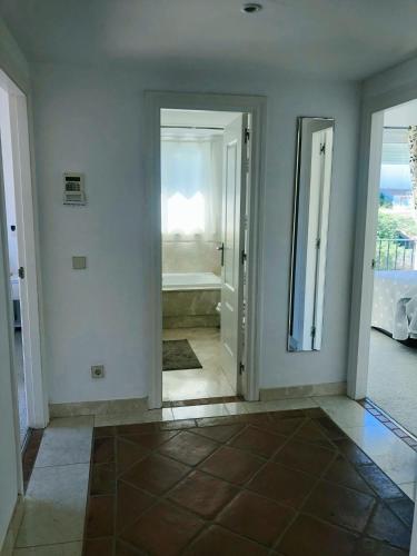 a room with a bathroom with a tub and a mirror at Detached Villa 4 bed Duquesa with Private infinity pool close to port and beach in Manilva