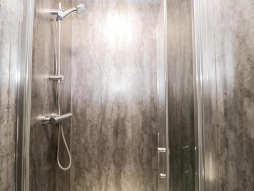 um chuveiro numa casa de banho com uma porta de vidro em 23 Deganwy Avenue em Llandudno