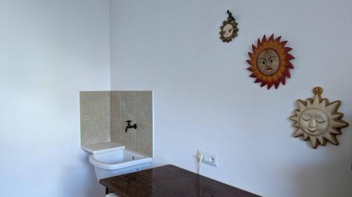 a bathroom with a toilet and a table and a mirror at Grazioso e confortevole attico, costa sud-ovest in Gonnesa
