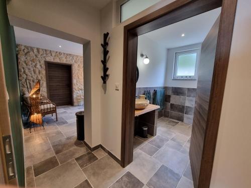 a bathroom with a walk in shower next to a bathroom at Apartments Suha Punta - Villa Babalonija in Kampor