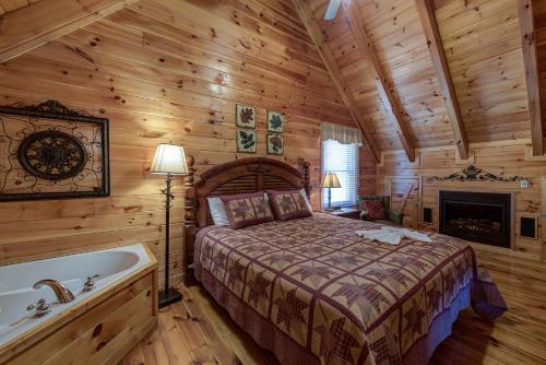 a bedroom with a bed and a tub in a log cabin at Aspen's Envy, 4 Bedrooms, Sleeps 16, Pool Table, Hot Tub, Mountain Views in Pigeon Forge