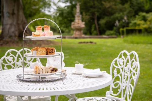a white table with three tiers of pastries on it at Berwick Lodge in Bristol