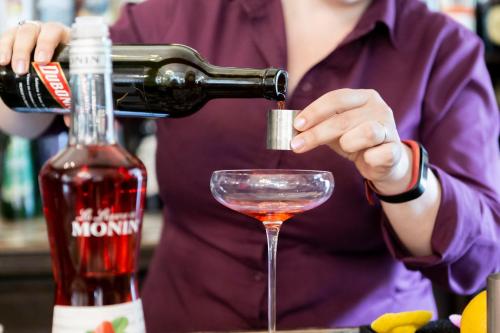 a woman pouring a drink into a martini glass at Berwick Lodge in Bristol
