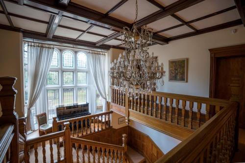 a staircase with a chandelier in a room at Berwick Lodge in Bristol
