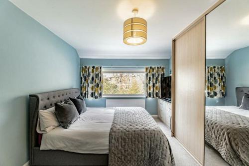 a bedroom with two beds and a mirror at 4 Bed in the heart of Hartford in Hartford