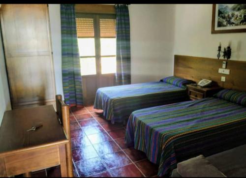 Postel nebo postele na pokoji v ubytování Posada de Jose Mª El Tempranillo