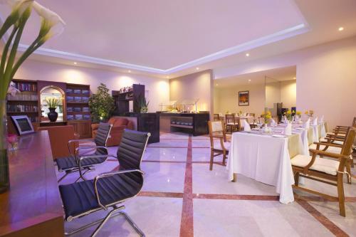 a dining room with white tables and chairs at Barceló Huatulco - All Inclusive in Santa Cruz Huatulco