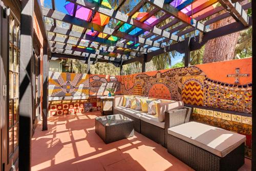 a patio with benches and a stained glass roof at The Gaudi House- Pool Minutes to DNTN and Beach in St. Augustine